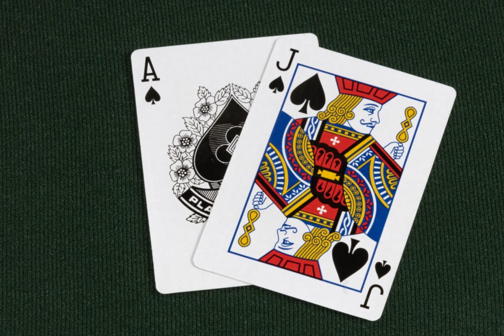 Blackjack cards showing 21 on a green felt table